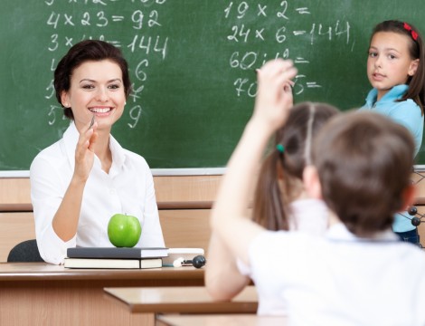 Beautiful teacher questions pupils at algebra