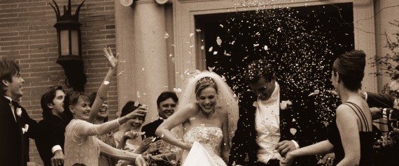 Wedding Party Throwing Rice at Newlyweds