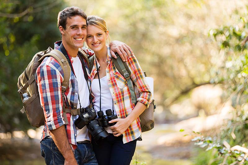 happy young couple hiking in mountain