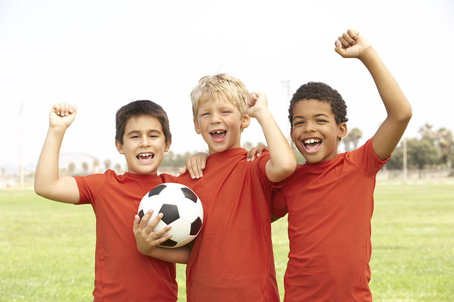 Young Girls In Football Team Celebrating